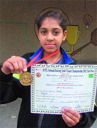 Yashi Sharma shows her table tennis medal.