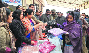 Members of the Ann Jal Sewa Trust, an NGO, distribute woollens among the needy at the Lord Mahavir Civil Hospital in Ludhiana on Wednesday. 