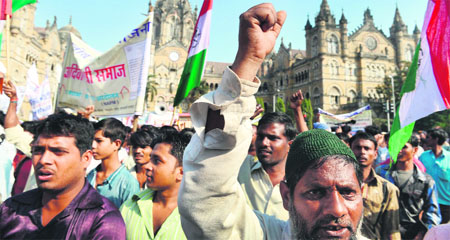 Slum-dwellers shout slogans at a rally in Mumbai on Wednesday to demand housing rights for the poor. 