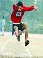 Participants during long jump and track events at the 43rd Annual Inter-College Athletics (Men & Women) Meet of Guru Nanak Dev University in Amritsar on Thursday. 