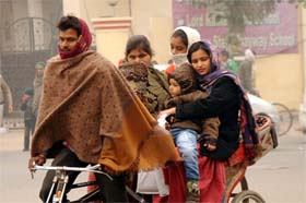 Braving the chill: A family wrapped in warm clothes, travels in a rickshaw to beat the chill in Bathinda. There was no respite for the residents from the biting cold on Thursday even as the sun came out during the afternoon