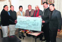 Chief Minister Vijay Bahuguna presents a cheque for Rs 11 lakh to Unmukt Chand, captain of the under-19 Indian cricket team, at a function in Dehradun on Thursday.
