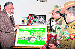 Col HRS Rana, in-charge of the Eco-Task Force, presents a memento to Chief Minister Vijay Bahuguna in Dehradun on Thursday