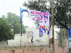 A hoarding of former minister Gopal Kanda torn by angry residents at Fatehabad. 