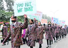 Students of SS International School, Karnal, hold a silent protest as they wear black ribbons and hold placards against the Delhi students rape.