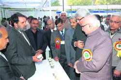 Haryana Agriculture Minister Paramvir Singh sees an exhibition with V-C KS Khokhar on his right, on Kisan Diwas function at CCS Haryana Agriculture University, Hisar.