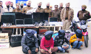 Four members of a gang of thieves in police custody with recoverd stolen goods in Kartarpur on Thursday. 