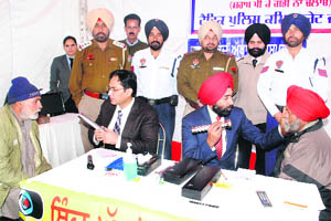 Doctors examine the eyes of drivers of various vehicles during a medical camp organised as a part of the Road Safety Week, being observed by the traffic police, in Jalandhar on Thursday. 