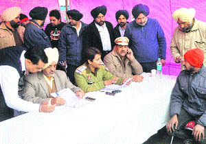 Traffic policemen interact with drivers during an awareness campaign organised as part of Road Safety Week in Ludhiana. 