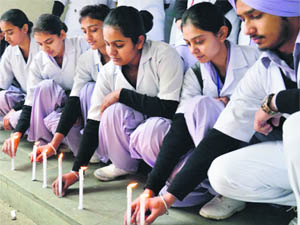 Staff of the Lord Mahavira Civil Hospital light candles in memory of the gang rape victim in Ludhiana. 