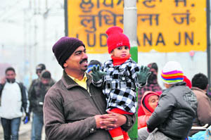 A man with his daughter at the Ludhiana railway station on Thursday morning.