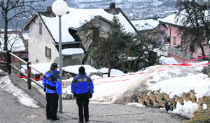 Police stand guard next to the gunmans house in Daillon village, Switzerland, on Thursday. 