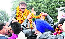 Industries Minister Mukesh Agnihotri is welcomed by party workers in Una on Friday. 