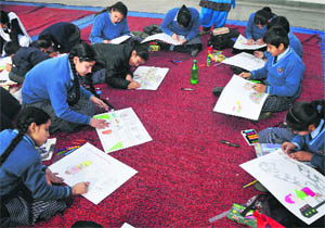 Students participate in painting competition in connection with the Road Safety Week 2013 at Kala Kendra in Jammu on Friday.