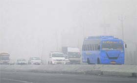 With headlights on, vehicles move at a snails pace due to fog on the GT Road in Jalandhar on Friday.