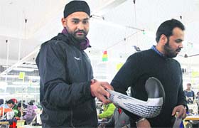 Hockey India League Mumbai Magician Sandeep Singh inspects the sports kit of the team at a Jalandhar sports unit on Friday.