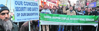 Members of the Kashmir Traders Association stage a protest against an acid attack on a woman in Srinagar on Friday. 