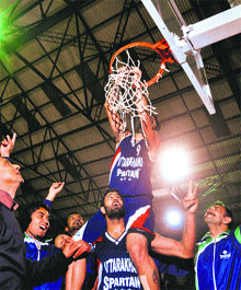 A player of Uttarakhand removes the net of the basket to celebrate their victory over Punjab during the National Basketball Championship that concluded in Ludhiana on Friday.