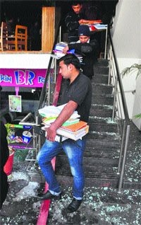 Employees take documents out of the restaurant.