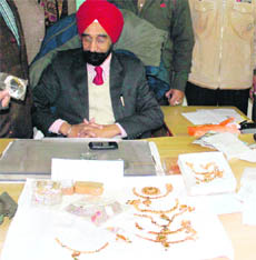 Excise and Taxation Department official shows seized gold jewellery and diamonds in Amritsar on Saturday. 
