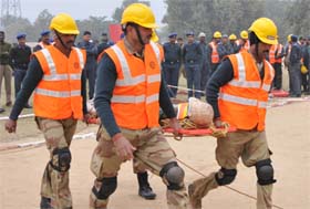 Personnel from various battalions (above and below) perform mock rescue operations on the Day I of the two-day training camp of National Disaster Response Force in Bathinda on Saturday.