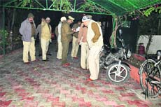 Policemen inspect the spot where driver Gurwinder Singh received bullet injuries outside Punjab MLA Rana Gurmeet Sodhis house in Sector 4, Panchkula, on Saturday.