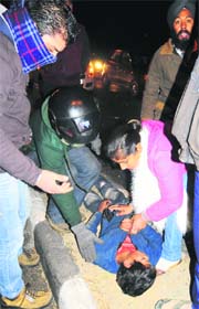 People help a child who was hit by a vehicle while crossing the road dividing Sectors 30 and 27 in Chandigarh on Saturday.