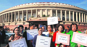 Opposition members raising the issue outside Parliament in New Delhi.