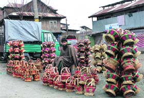 A roadside vendor sells traditional fire pots, kangris, in Srinagar on Satur