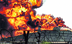 Flames billow out of a storage tank of IOC's Hazira terminal in Gujarat on Saturday