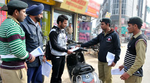 NCC cadets distributing pamphlets to create traffic awareness among the commuters.