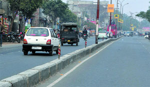 The iron railing on th road divider has gone missing, having fallen prey to drug addicts.