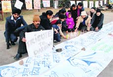 Members of the Unique Society of Artists, Panchkula, pay homage to the Delhi rape victim through paintings on Sunday.