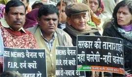 BJP activists holds placards during a demonstration against the brutal rape case at Jantar Mantar in New Delhi on Sunday.
