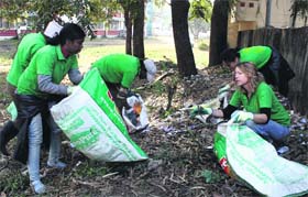 Volunteers of the Waste Warriors collect garbage from outside the office of the SSP in Dehradun on Sunday