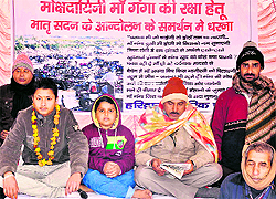 Young Vasu and Veer Singh sit on a symbolic agitation against quarrying on the Ganga riverbed at Chandracharya chowk in Haridwar on Sunday