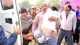 A differently abled child, who fainted due to cold, being shifted to an ambulance at Sirsa on Sunday.