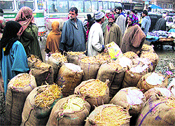 Fighting the chill With the cold wave tightening its grip over the region, a vendor sells charcoal bags in Srinagar on Sunday