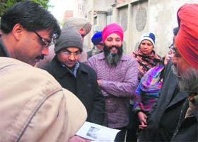 Kumar Rahul, Deputy Commissioner, Sangrur, and SDM, Malerkotla, Rajesh Tripathi study the documentary evidence during their visit to Street No. 3 at Mohalla Amarpura in Mandi Ahmedgarh