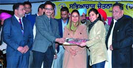 Bathinda MP Harsimrat Kaur Badal presents Lohri Award to an achiever in Mansa on Monday.