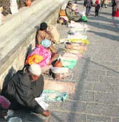 Beggars sit on the stairs of the shrine of Sufi saint Sheikh Hamza Makhdoomi during a festival on his birth anniversary in Srinagar. 