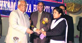 he gives a scholarship certificate to a students in Jalandhar.