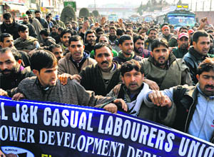 Members of the All Jammu and Kashmir Casual Labourers Union of Power Development Department protest against the state government for not fulfilling their long pending demands in Srinagar on Monday. 