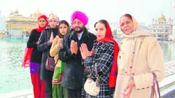 NRI Satinder Sidhwan pays obeisance at the Golden Temple on Tuesday. 