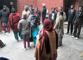 Teachers stand outside the In-Service Training Centre in Bathinda on Tuesday. The centre is not spacious enough to accommodate all the teachers at a time. 