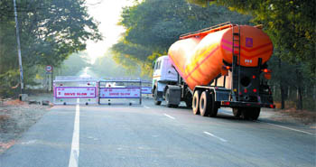 A heavy vehicle makes its way through the temporary barricade in the cantonment area. Smaller vehicles are left with little space as trucks drive past at speed even in these areas.