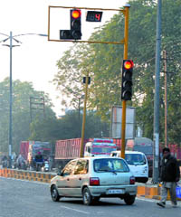 A car jumps the red light at the traffic intersection.