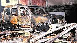 A burnt car and debris after a fire at a showroom in Phase VI, Mohali, on Tuesday