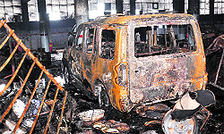 A burnt car and debris after a fire at a showroom in Phase VI, Mohali, on Tuesday