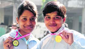 Nandani Tiwari (Bronze) and Puja Yadav (Gold), medal winners, at the recent Inter-University Boxing Meet 2012-13.